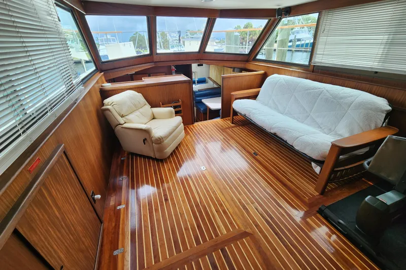 Slide: The Image of Interior of 1983 Hatteras 48 Motor Yacht with wood flooring and comfortable seating. - 4