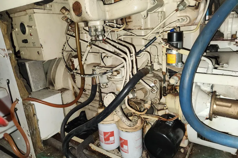 Slide: The Image of Engine compartment of a 1983 Hatteras 48 Motor Yacht, showing mechanical components and wiring. - 40