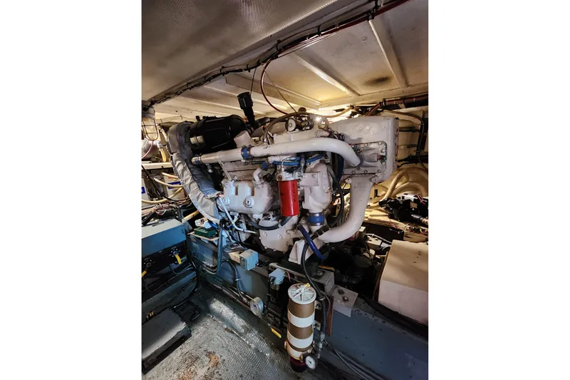 Slide: The Image of Engine room of a 1983 Hatteras 48 Motor Yacht, showcasing detailed machinery. - 42