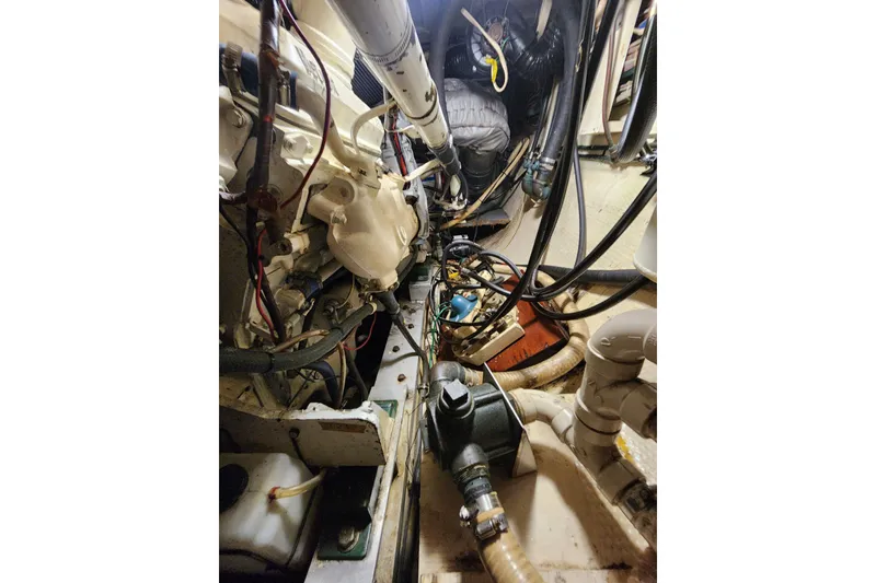 Slide: The Image of Engine room of a 1983 Hatteras 48 Motor Yacht with visible machinery and wiring. - 43