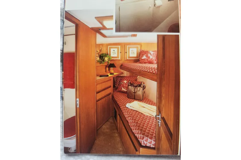 Slide: The Image of Interior of 1983 Hatteras 48 Motor Yacht with cozy bunk beds and wooden cabinetry. - 47
