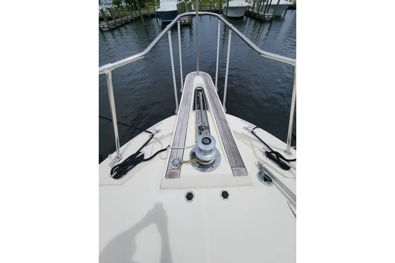 Slide: The Image of Bow view of 1983 Hatteras 48 Motor Yacht with anchor winch and railing. - 7