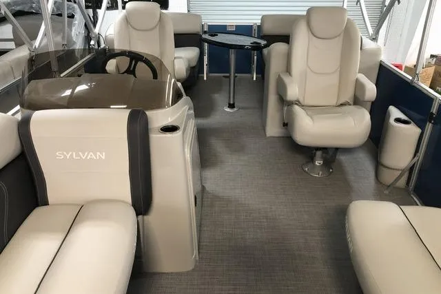 Slide: The Image of 2024 Sylvan Mirage 820 LZ pontoon boat interior with plush seating and steering console. - 1