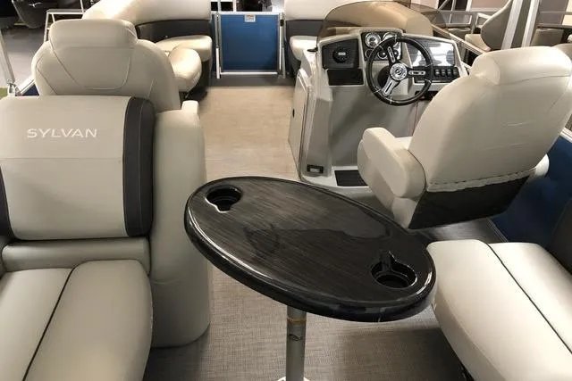 Slide: The Image of 2024 Sylvan Mirage 820 LZ boat interior with plush seating and modern helm. - 2
