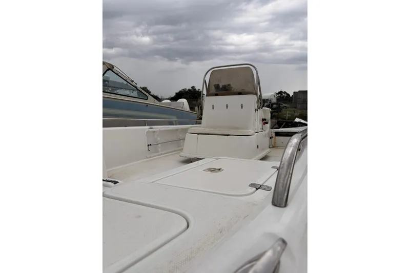 Slide: The Image of 2004 Fishmaster 24 boat with center console, under cloudy sky. - 8