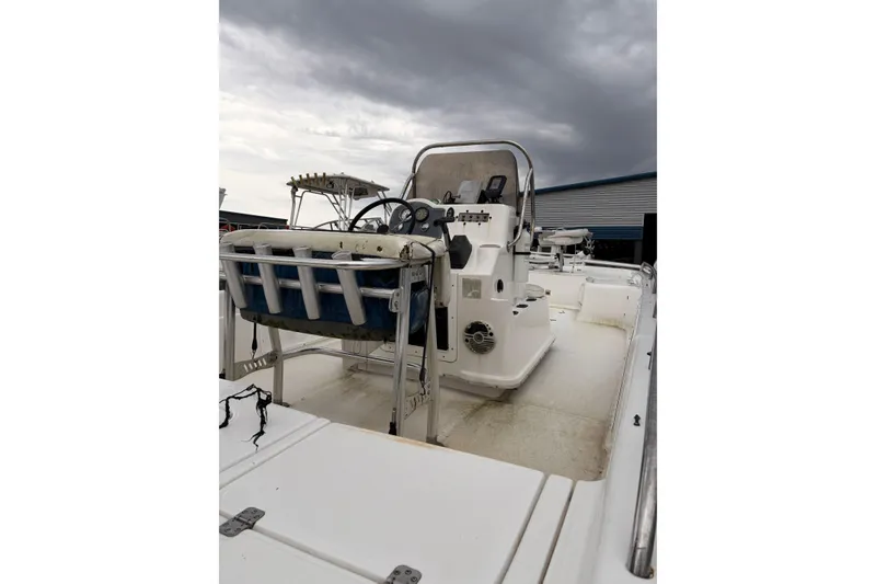 Slide: The Image of 2004 Fishmaster 24 boat with center console under cloudy sky. - 5