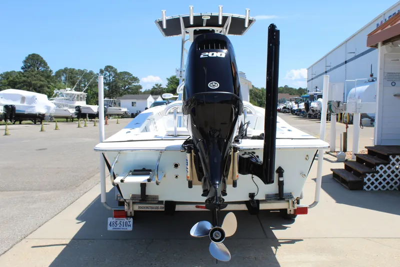 Slide: The Image of Rear view of a 2023 Intruder 23 boat with outboard motor. - 1