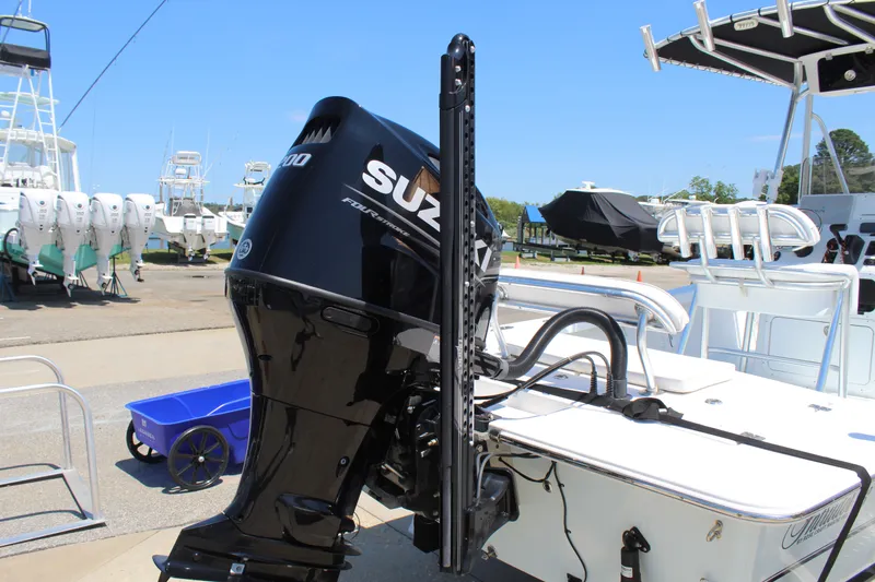 Slide: The Image of 2023 Intruder 23 boat with Suzuki outboard motor at the marina. - 12