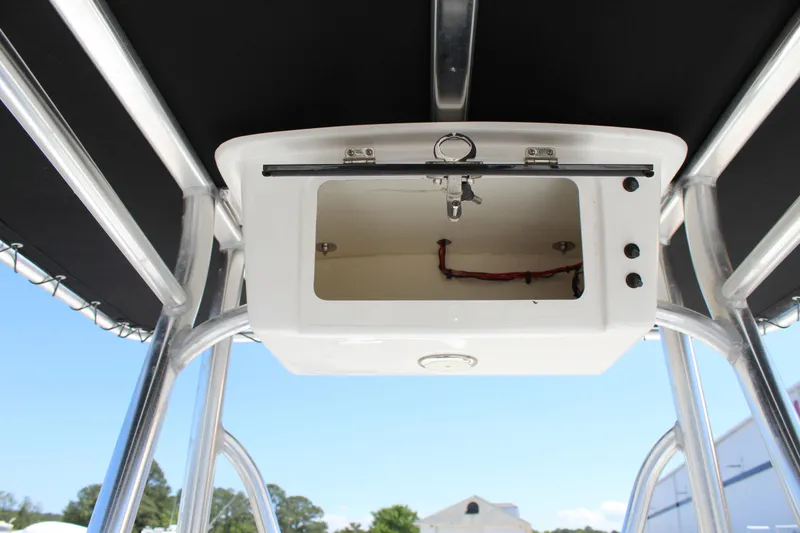 Slide: The Image of 2023 Intruder 23 boat console with open storage compartment. - 21