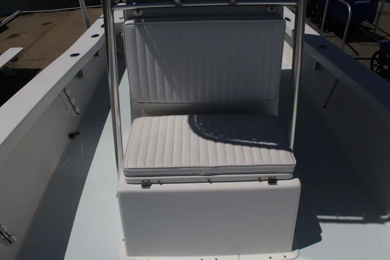 Slide: The Image of 2023 Intruder 23 boat with cushioned seating area. - 29