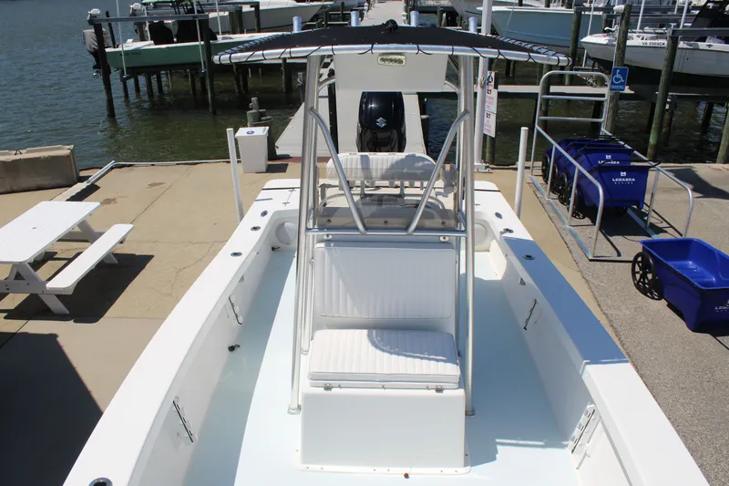 Slide: The Image of 2023 Intruder 23 boat at dock with seating area. - 30