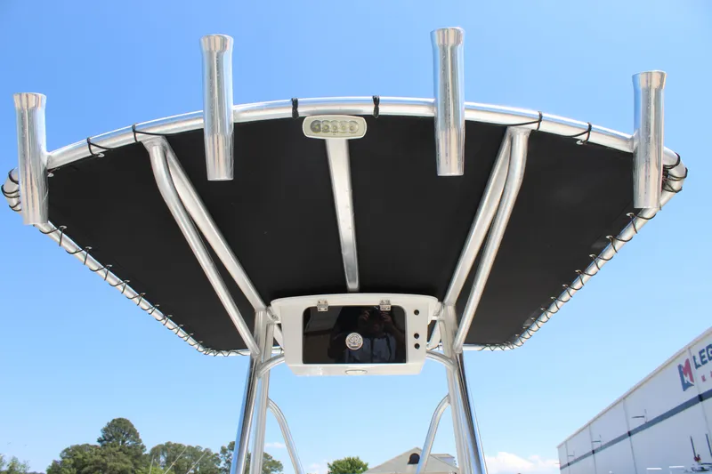 Slide: The Image of 2023 Intruder 23 boat with black canopy and rod holders. - 33