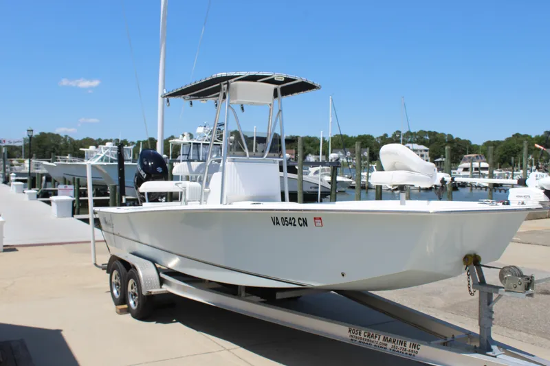 Slide: The Image of 2023 Intruder 23 boat on trailer at marina. - 6