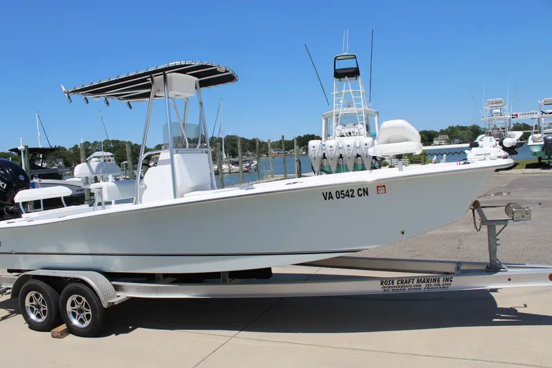 Slide: The Image of 2023 Intruder 23 boat on trailer parked at marina. - 7