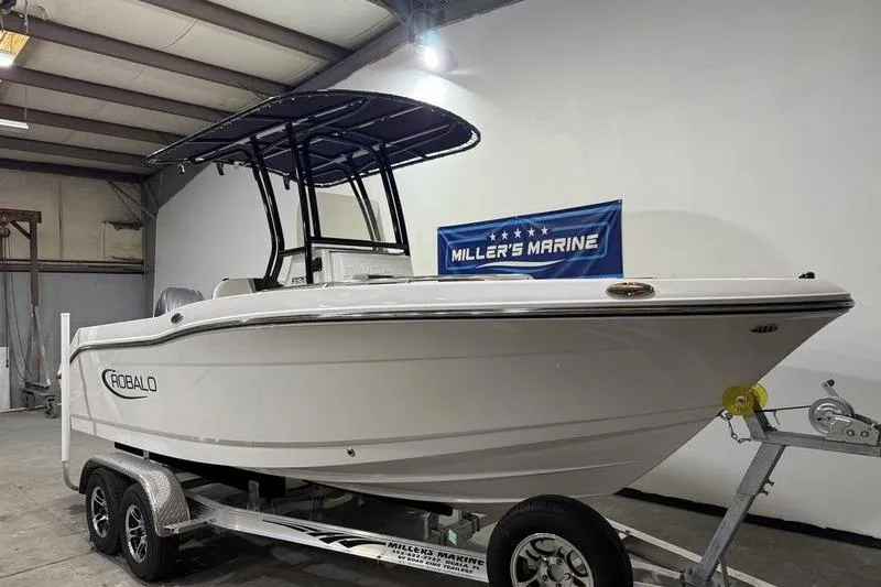 Slide: The Image of 2026 Robalo R200 Center Console boat on trailer at Miller's Marine showroom. - 1