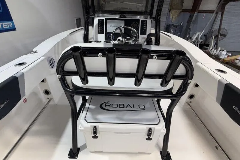 Slide: The Image of 2026 Robalo R200 Center Console boat interior with rod holders and steering console. - 10