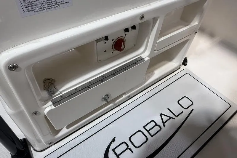 Slide: The Image of 2026 Robalo R200 Center Console boat interior with storage compartments and logo. - 11
