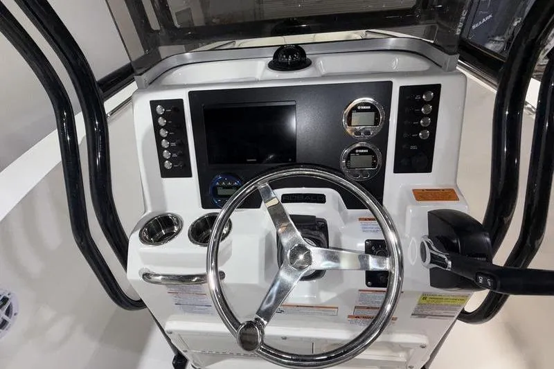Slide: The Image of 2026 Robalo R200 Center Console dashboard with steering wheel and control panel. - 13