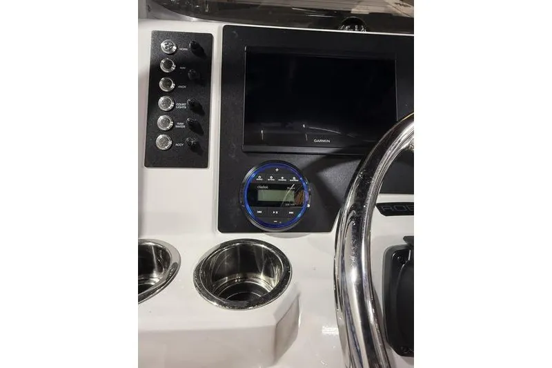 Slide: The Image of 2026 Robalo R200 Center Console dashboard with Garmin display and controls. - 16