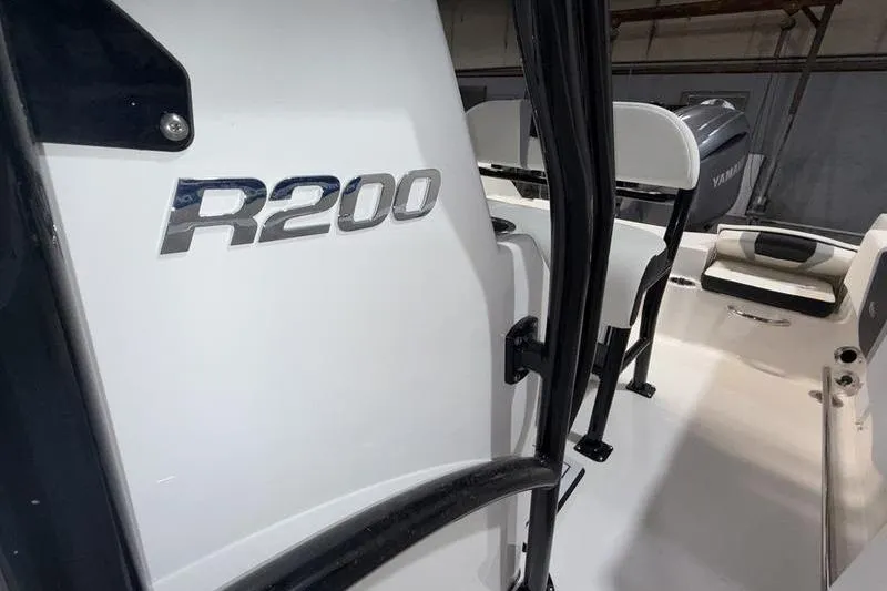 Slide: The Image of 2026 Robalo R200 Center Console boat interior with seating and Yamaha engine. - 17