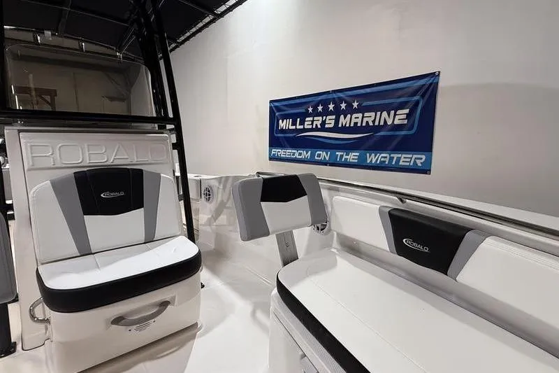 Slide: The Image of 2026 Robalo R200 Center Console interior with seating, Miller's Marine banner displayed. - 19