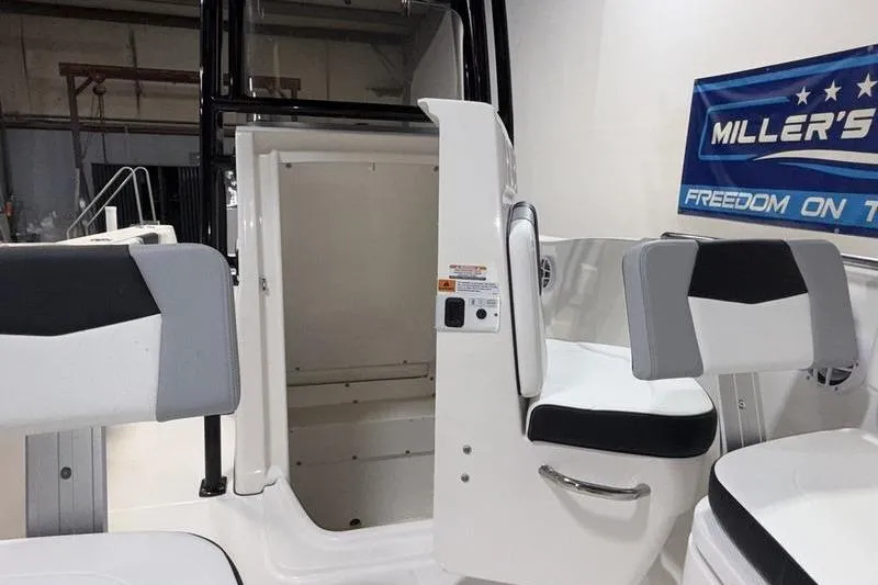 Slide: The Image of 2026 Robalo R200 Center Console interior with seating and storage compartment. - 20