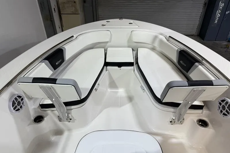 Slide: The Image of 2026 Robalo R200 Center Console boat interior with white cushioned seating. - 23
