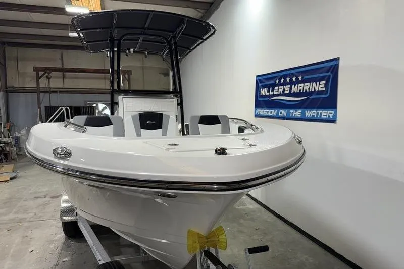 Slide: The Image of 2026 Robalo R200 Center Console boat in showroom with Miller's Marine banner. - 3