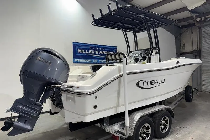Slide: The Image of 2026 Robalo R200 Center Console boat on trailer in showroom. - 4
