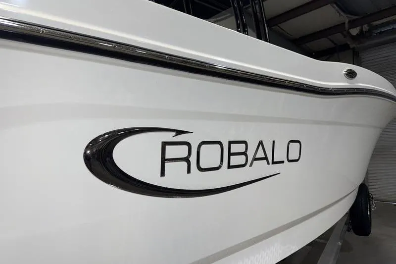Slide: The Image of 2026 Robalo R200 Center Console boat, sleek white exterior with logo. - 5