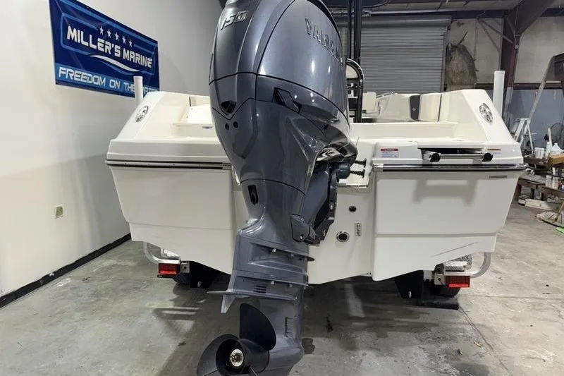 Slide: The Image of 2026 Robalo R200 Center Console boat with Yamaha V6 outboard motor in a showroom. - 6