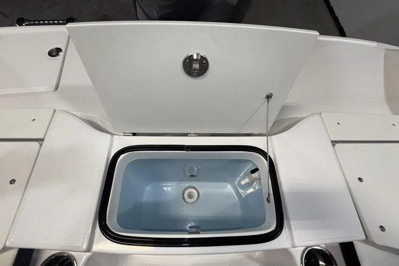 Slide: The Image of 2026 Robalo R200 Center Console livewell with open lid, showcasing interior design. - 9