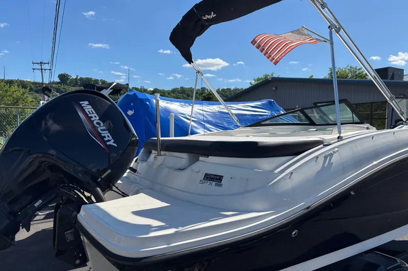 Slide: The Image of 2022 Sea Ray SPX 190 Outboard boat with Mercury engine, docked under clear blue sky. - 2
