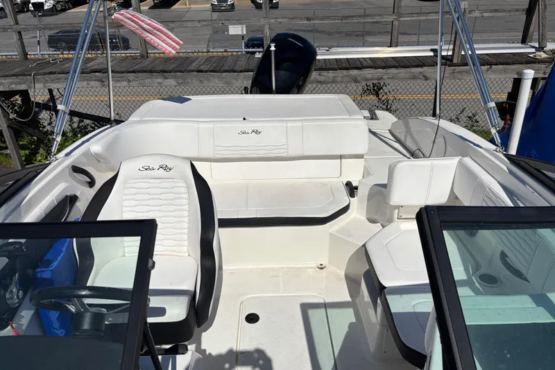 Slide: The Image of 2022 Sea Ray SPX 190 Outboard boat interior with white seating and steering wheel. - 8