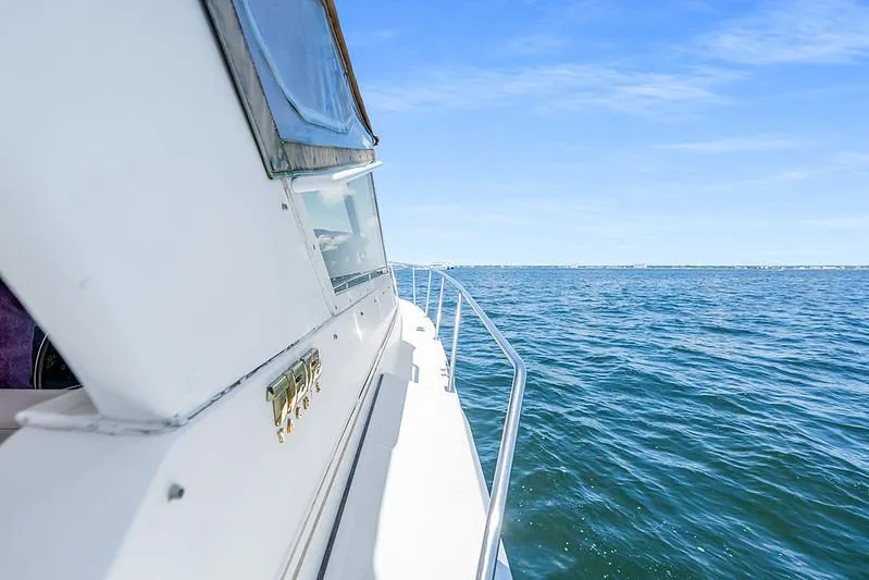 Slide: The Image of 2000 Tiara 3500 EXPRESS yacht cruising on open blue waters under clear skies. - 14