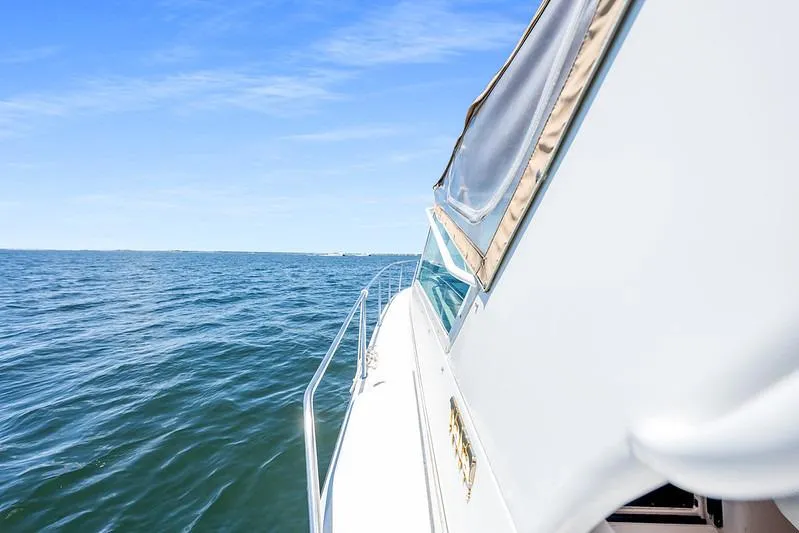 Slide: The Image of Side view of a 2000 Tiara 3500 EXPRESS boat cruising on open water. - 15