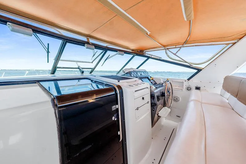 Slide: The Image of Interior view of 2000 Tiara 3500 EXPRESS yacht cockpit with steering wheel and seating. - 16