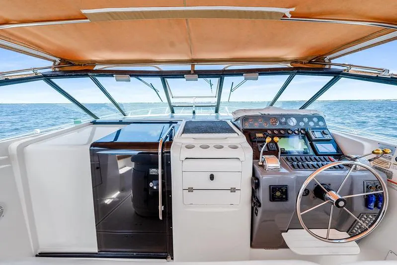Slide: The Image of Cockpit view of 2000 Tiara 3500 EXPRESS yacht with steering wheel and control panel. - 17