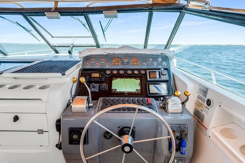 Slide: The Image of Cockpit of 2000 Tiara 3500 EXPRESS yacht with navigation instruments and steering wheel. - 18