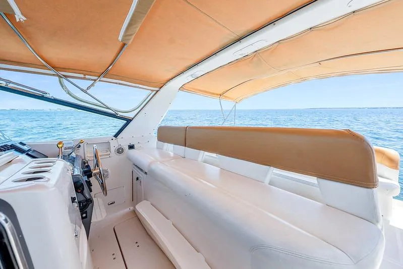 Slide: The Image of Interior view of 2000 Tiara 3500 EXPRESS yacht with tan canopy and ocean backdrop. - 19