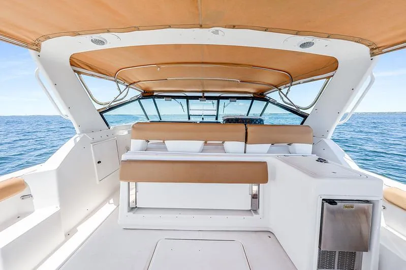 Slide: The Image of 2000 Tiara 3500 EXPRESS yacht interior with tan seating and ocean view. - 21