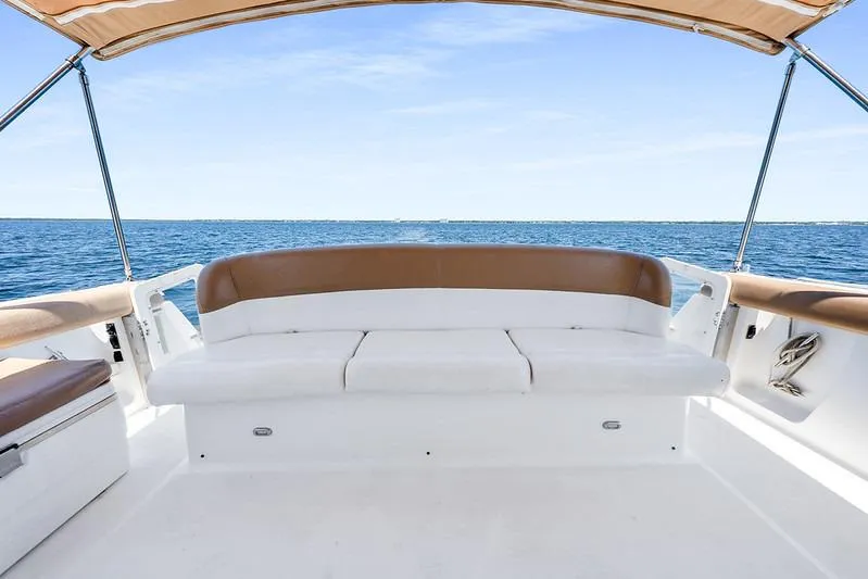 Slide: The Image of Tiara 3500 EXPRESS 2000 boat with cushioned seating, ocean view, and canopy. - 25