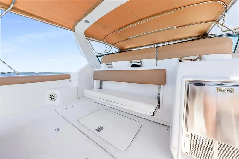 Slide: The Image of 2000 Tiara 3500 EXPRESS boat interior with tan seating and stainless steel features. - 27