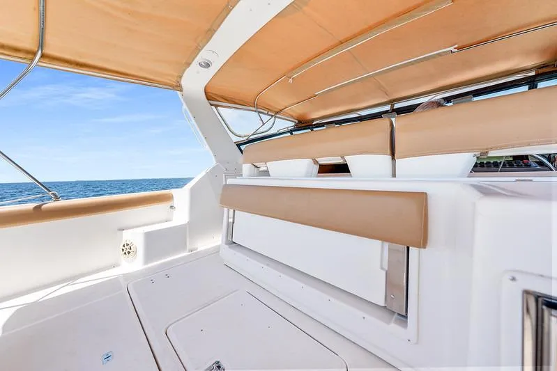 Slide: The Image of 2000 Tiara 3500 EXPRESS boat interior with tan seating and ocean view. - 28