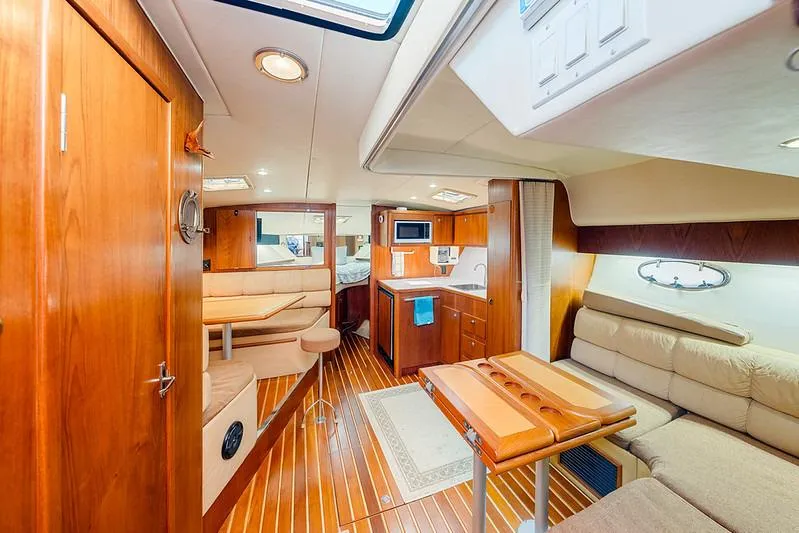 Slide: The Image of Luxurious interior of 2000 Tiara 3500 EXPRESS yacht with wood finishes and cozy seating. - 32