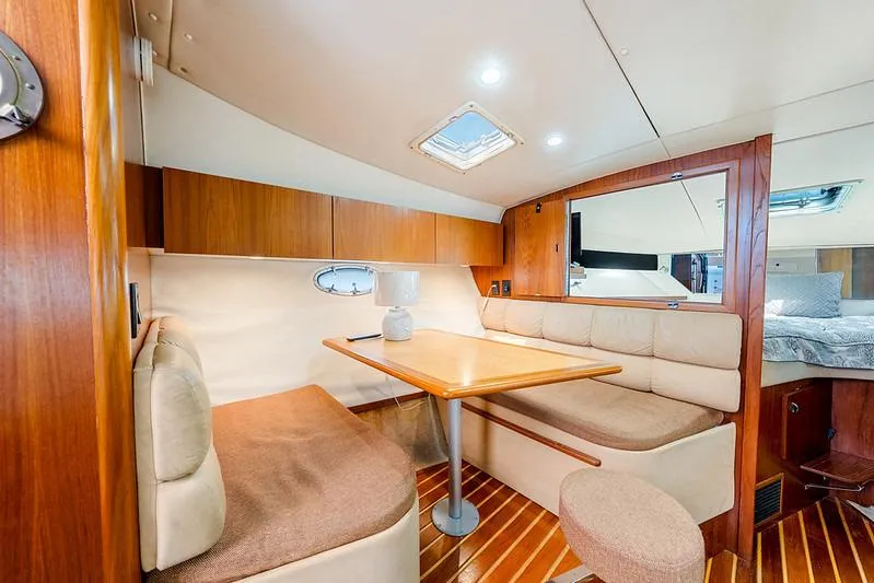 Slide: The Image of Interior of 2000 Tiara 3500 EXPRESS yacht with cozy dining area and wooden finishes. - 35