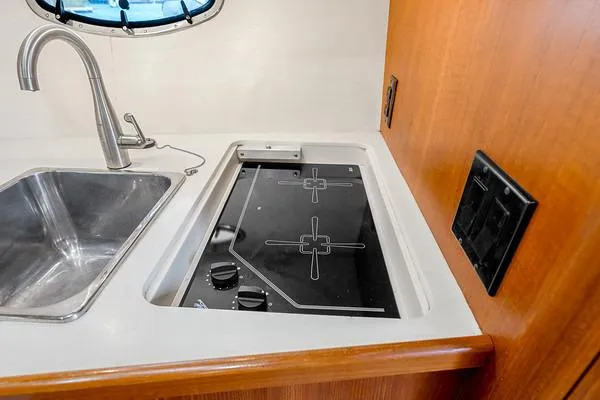 Slide: The Image of Tiara 3500 EXPRESS 2000 yacht kitchen with sink and stovetop. - 37