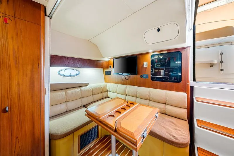 Slide: The Image of Interior of 2000 Tiara 3500 EXPRESS yacht with cozy seating and wooden accents. - 38