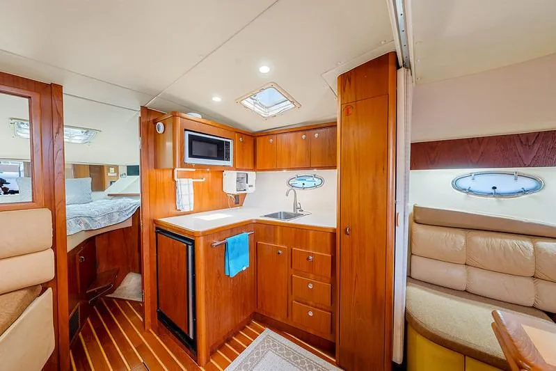 Slide: The Image of Interior of 2000 Tiara 3500 EXPRESS yacht with kitchenette and seating area. - 39