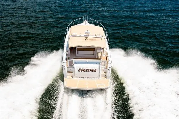 Slide: The Image of Tiara 3500 EXPRESS 2000 yacht cruising on open water, rear view. - 4